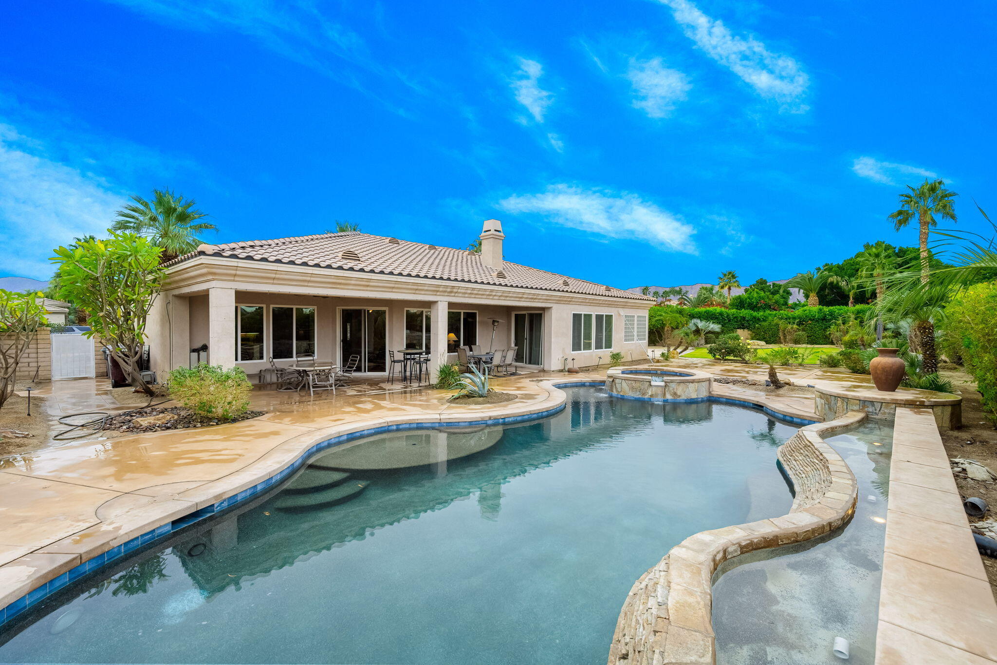 80262 Amazon Indio, CA 92201 - Photo 16 of 45 a view of a house with swimming pool and sitting area