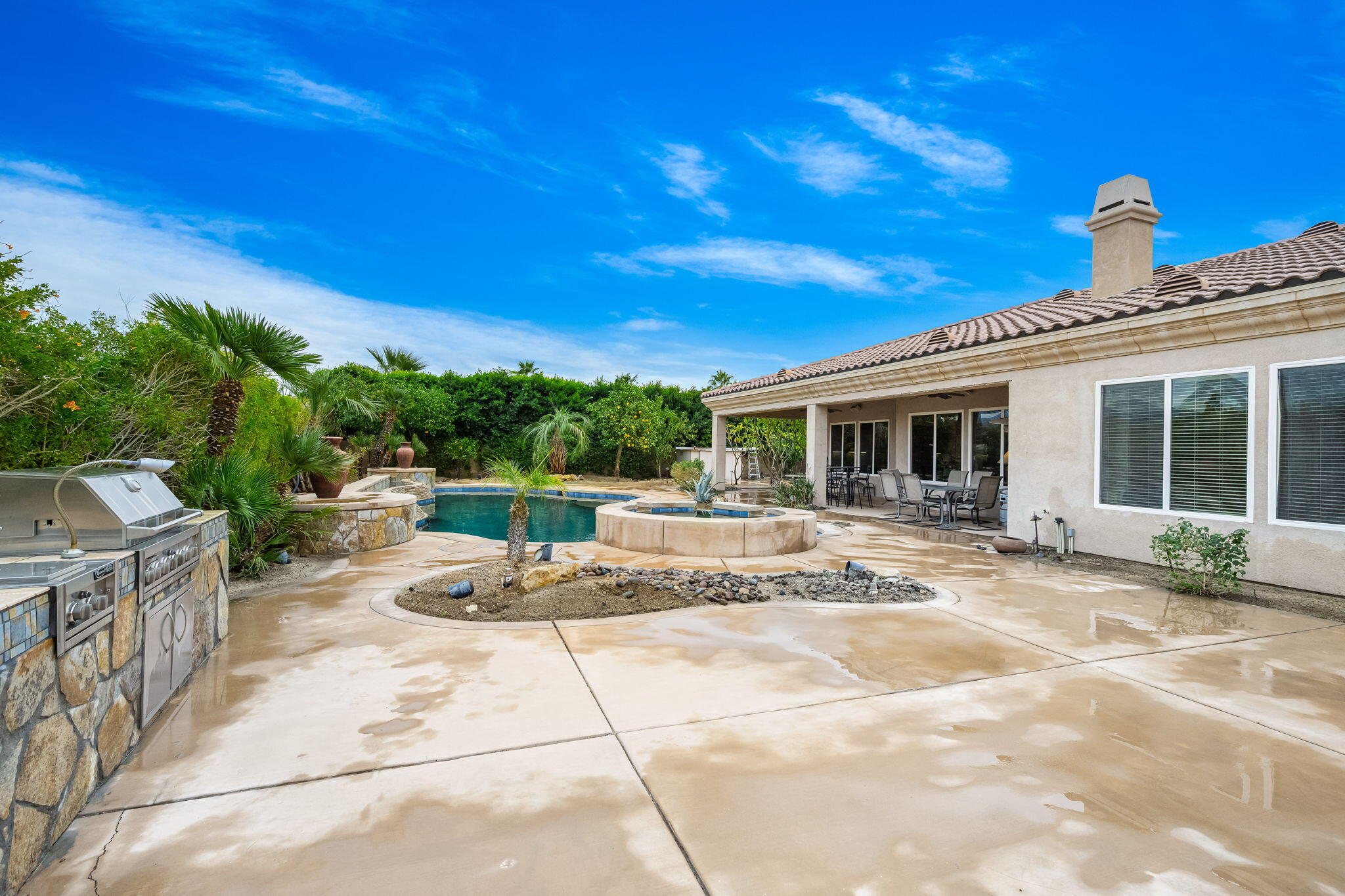 80262 Amazon Indio, CA 92201 - Photo 19 of 45 a view of a patio with a dining table and chairs with wooden floor and fence