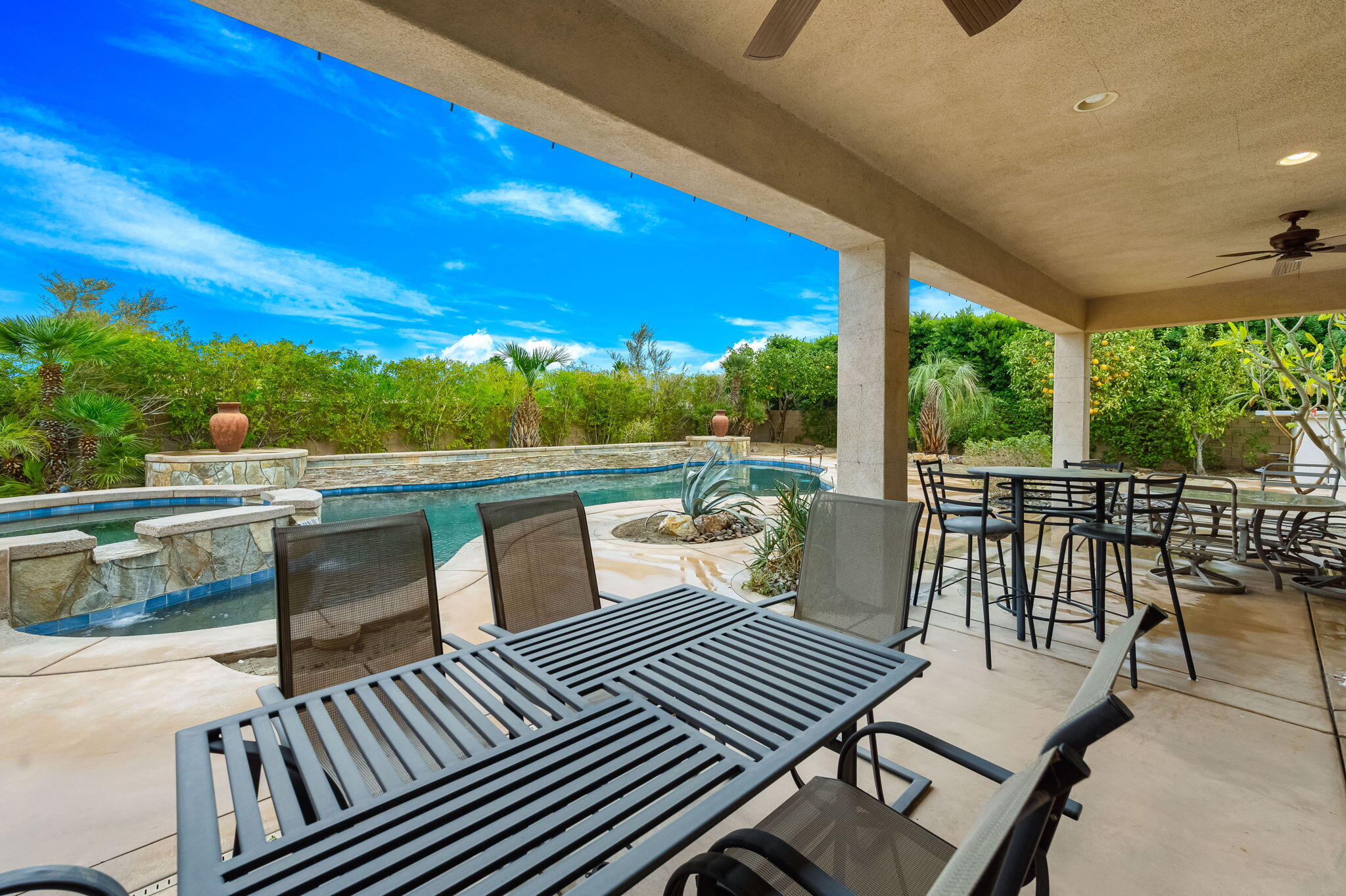 80262 Amazon Indio, CA 92201 - Photo 23 of 45 a view of a patio with dining table and chairs with wooden floor and fence