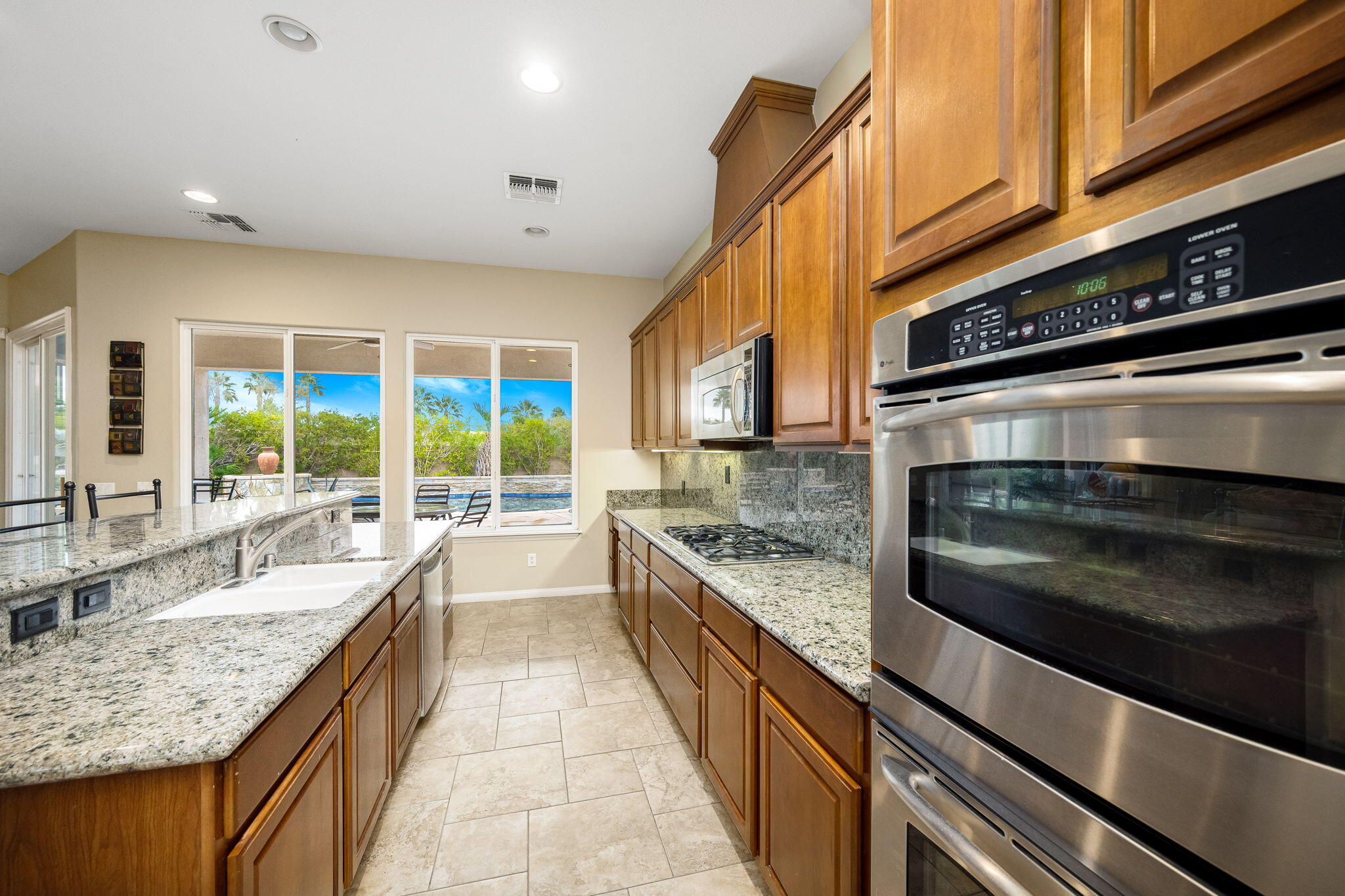 80262 Amazon Indio, CA 92201 - Photo 29 of 45 a large kitchen with granite countertop a stove and cabinets