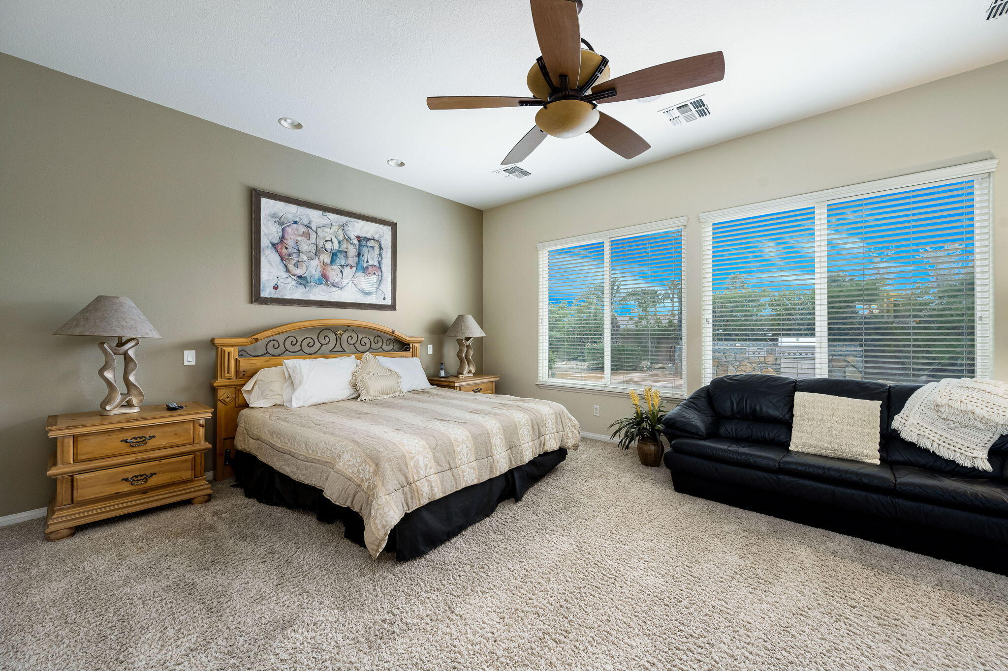 80262 Amazon Indio, CA 92201 - Photo 34 of 45 a bedroom with a large bed couch and a large window