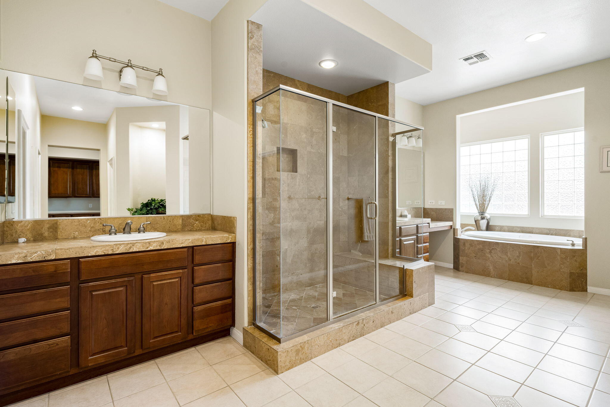 80262 Amazon Indio, CA 92201 - Photo 35 of 45 a bathroom with a granite countertop sink a mirror and a bathtub