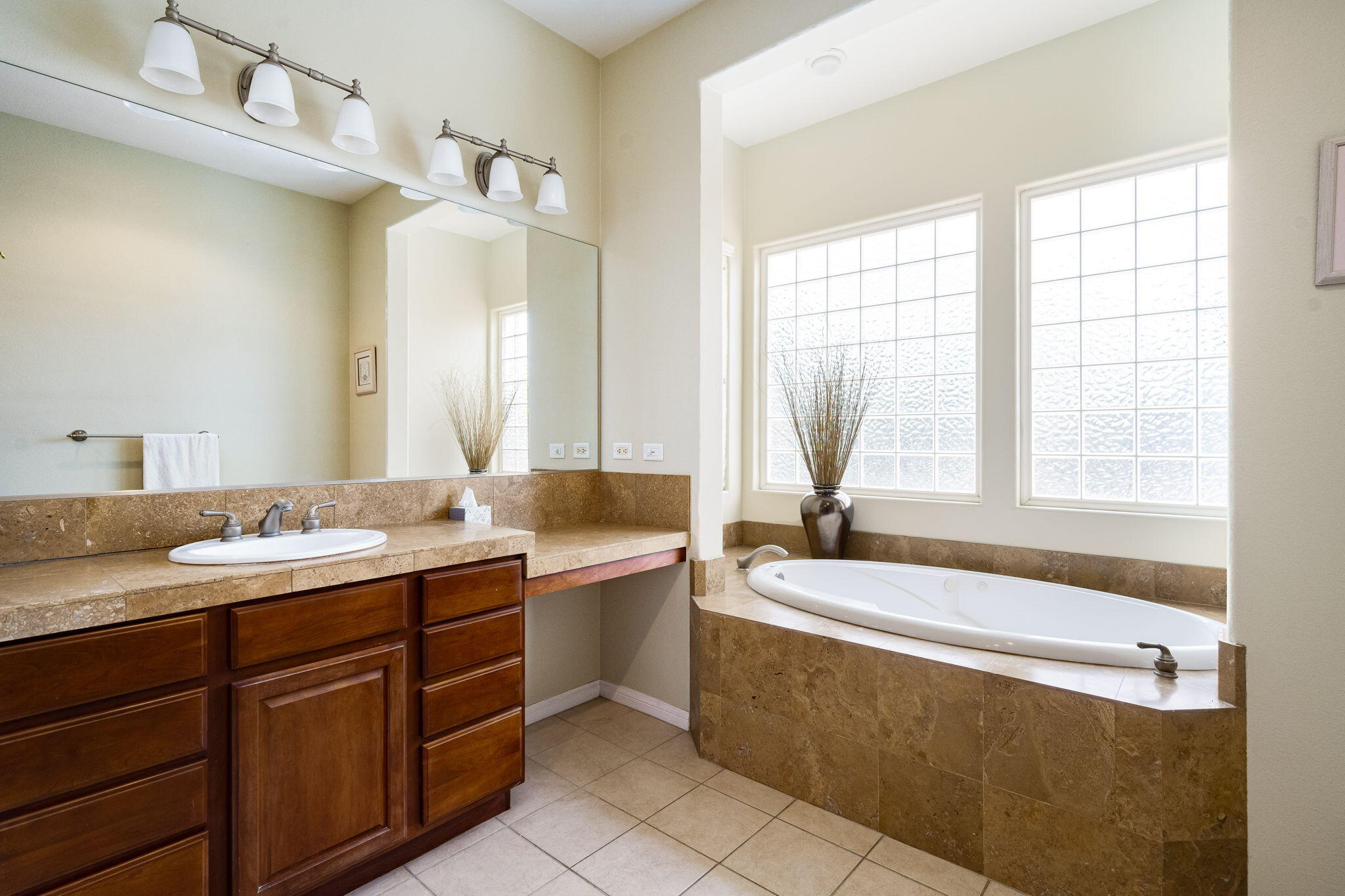 80262 Amazon Indio, CA 92201 - Photo 37 of 45 a bathroom with a granite countertop tub sink and mirror