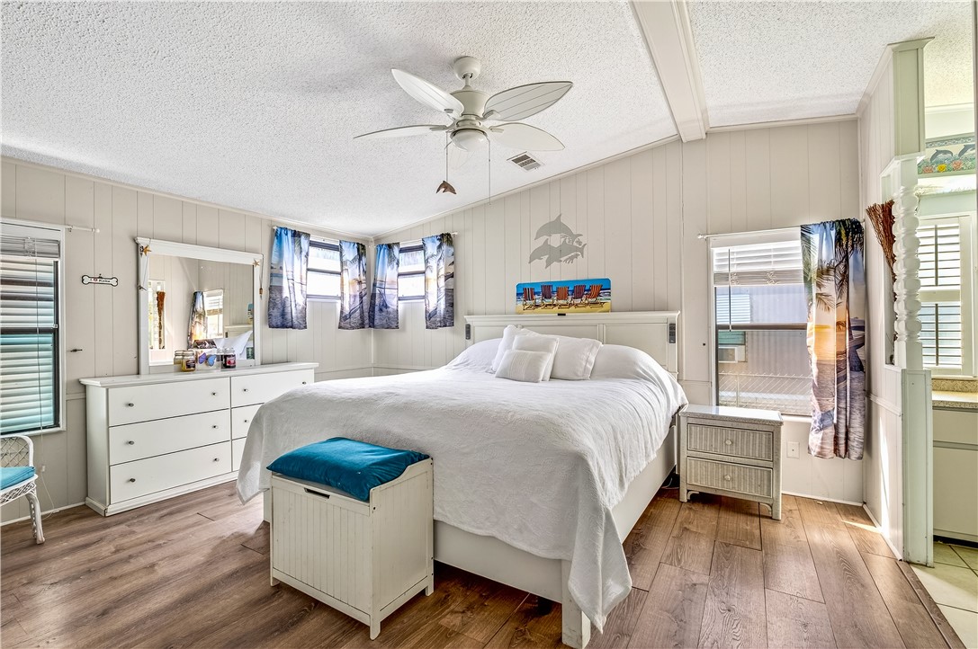717 Wedelia Drive Sebastian, FL 32976 - Photo 12 of 24 a bed room with a bed and a ceiling fan