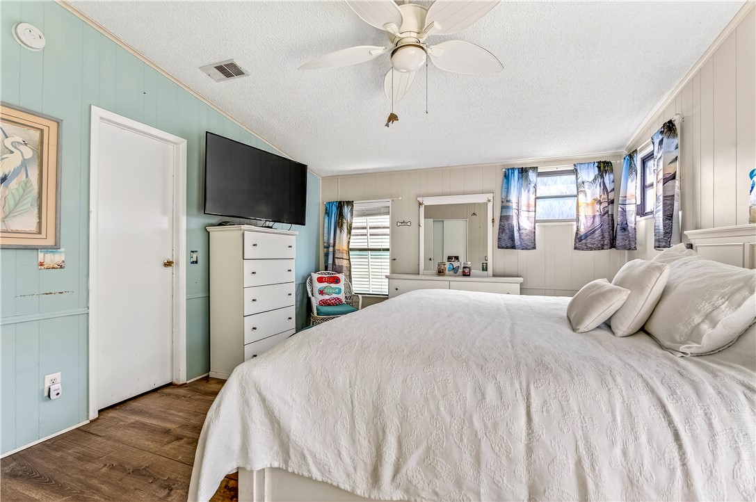 717 Wedelia Drive Sebastian, FL 32976 - Photo 13 of 24 a bedroom with a bed and a flat screen tv