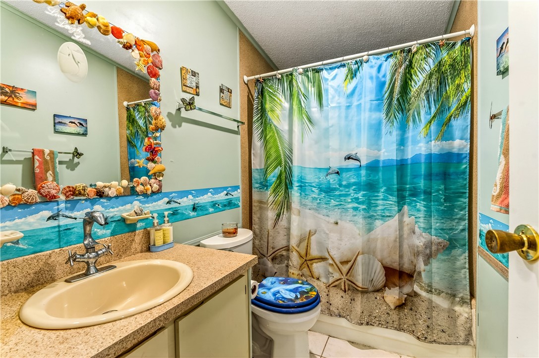 717 Wedelia Drive Sebastian, FL 32976 - Photo 16 of 24 a bathroom with a sink toilet and a mirror