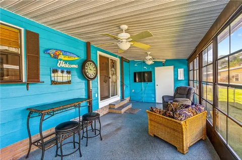 an aerial view of residential houses with outdoor space and trees