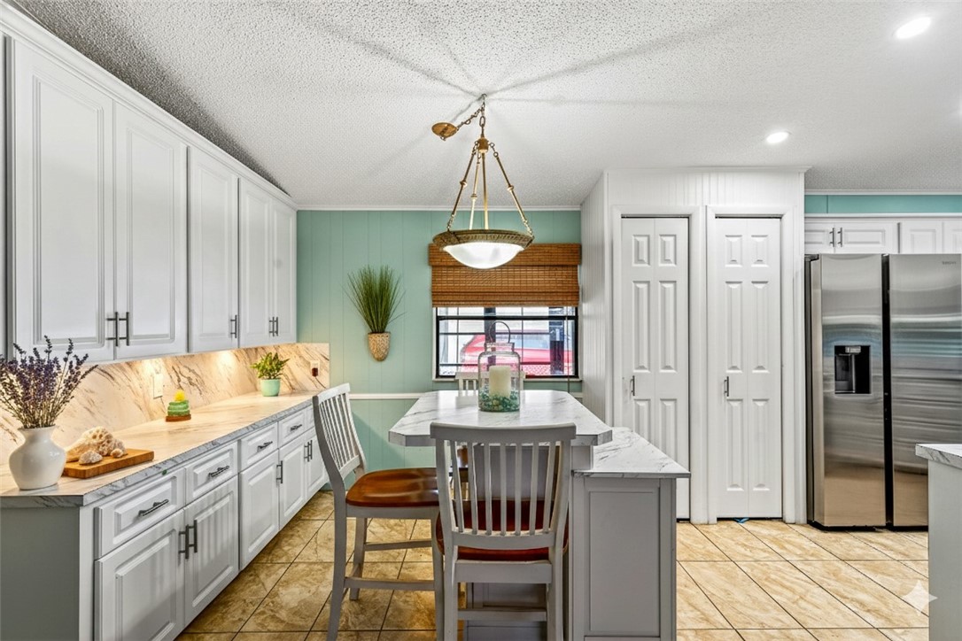 717 Wedelia Drive Sebastian, FL 32976 - Photo 6 of 24 a very nice looking dining room with a large window and chandelier