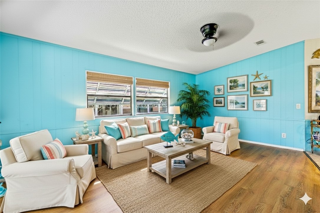 717 Wedelia Drive Sebastian, FL 32976 - Photo 10 of 24 a living room with furniture and a large window