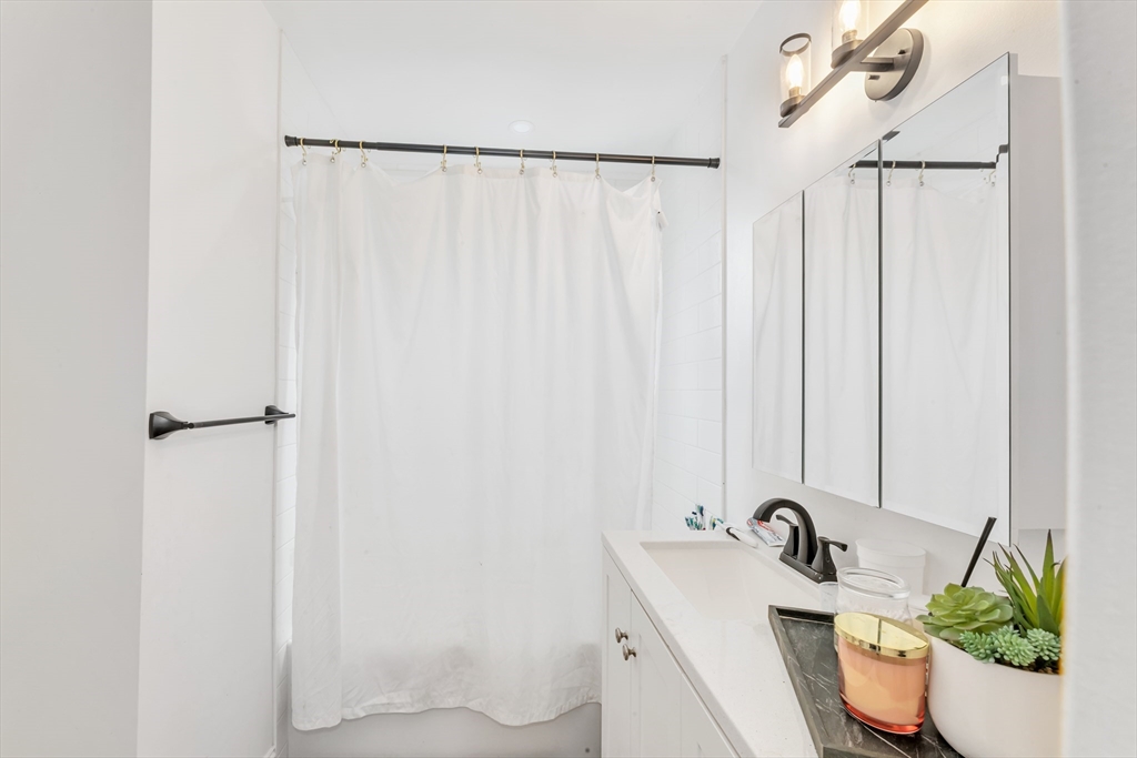 36 Brookledge Street Boston, MA 02121 - Photo 12 of 31 a bathroom with a sink and a mirror