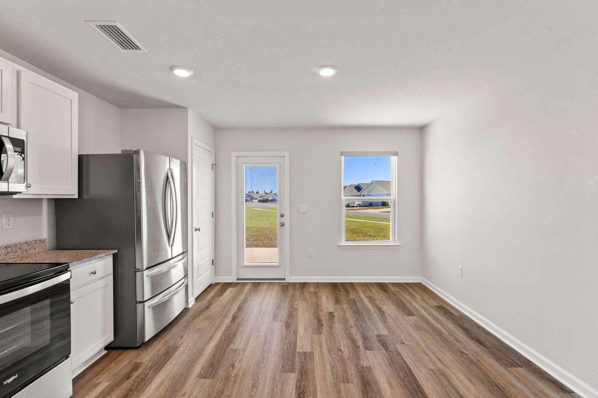6570 Atkins Road Panama City, FL 32404 - Photo 13 of 50 a view of a kitchen with a stove cabinets and wooden floor