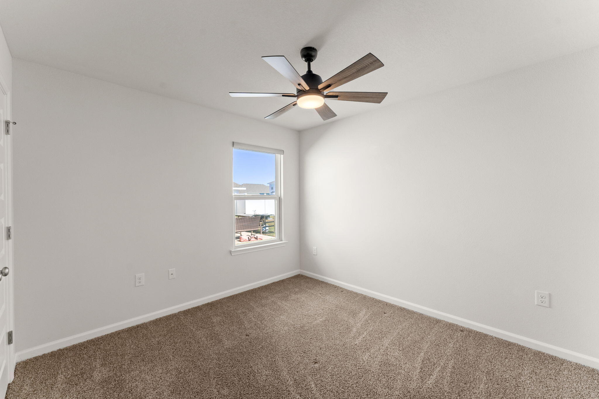 6570 Atkins Road Panama City, FL 32404 - Photo 15 of 50 an empty room with a window and a fan