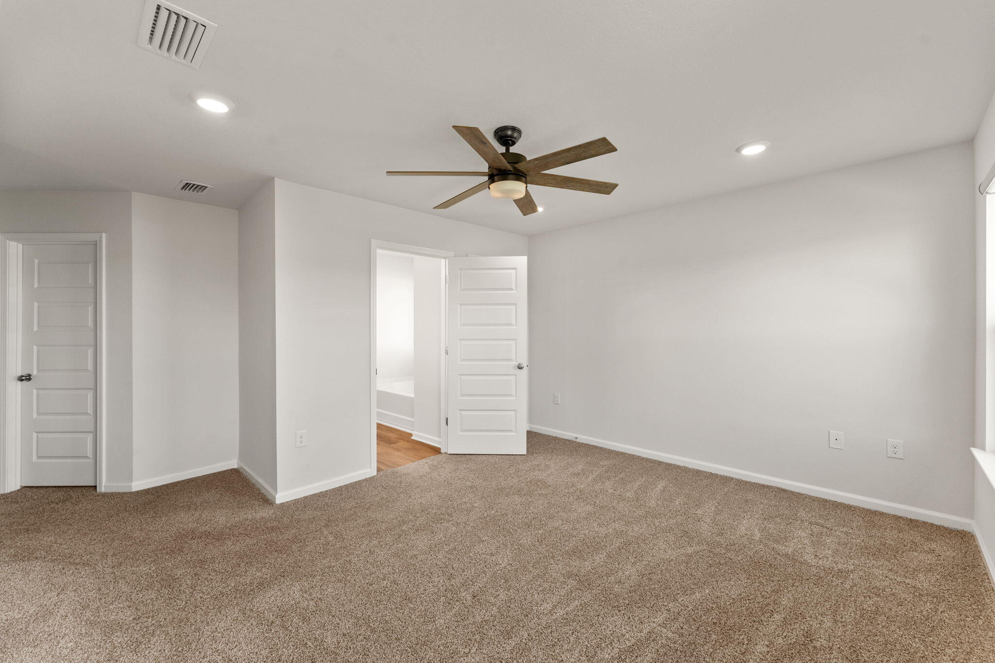6570 Atkins Road Panama City, FL 32404 - Photo 24 of 50 a view of a room with a ceiling fan and carpet