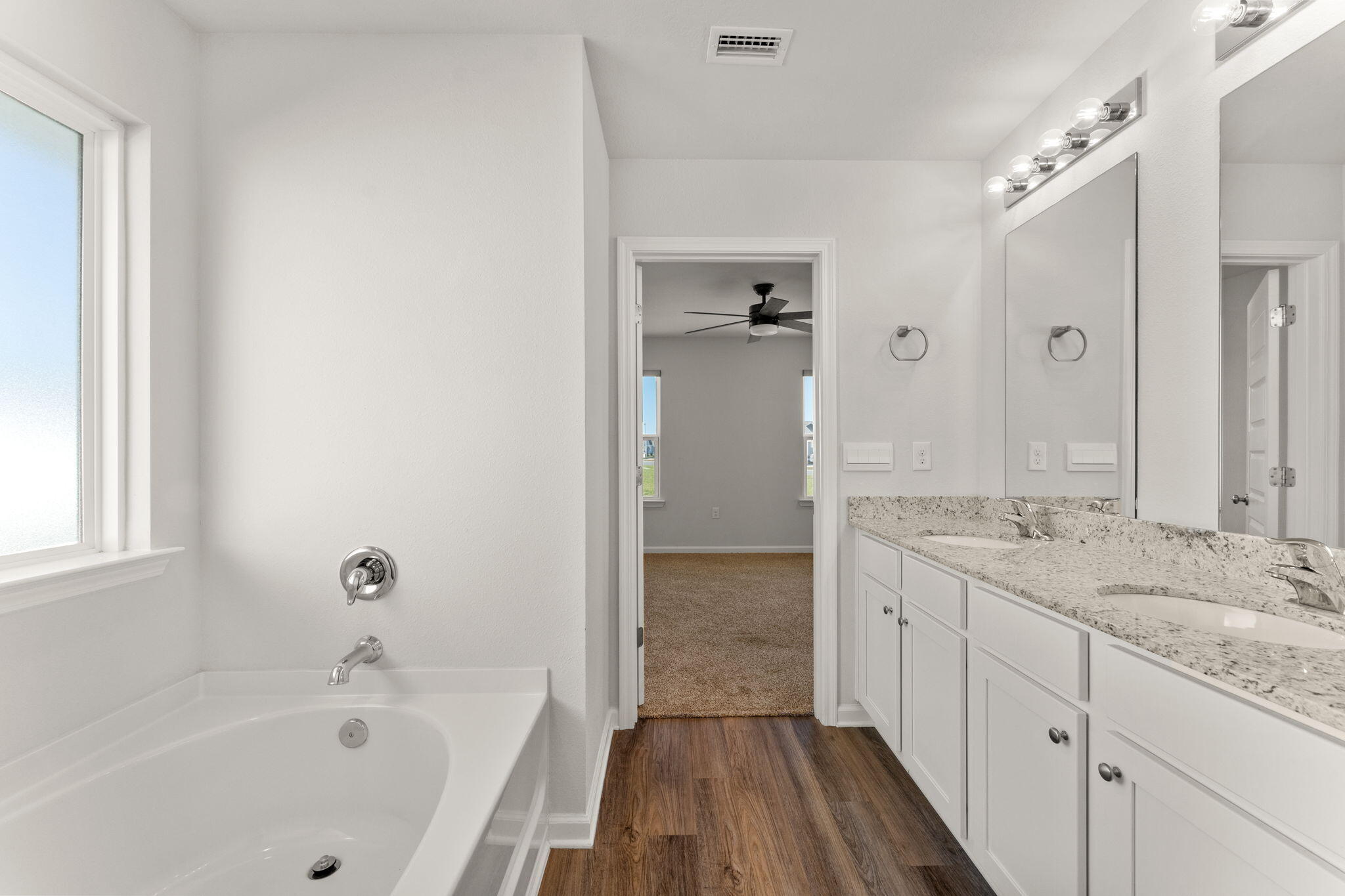 6570 Atkins Road Panama City, FL 32404 - Photo 28 of 50 a bathroom with a granite countertop sink a mirror bathtub and shower