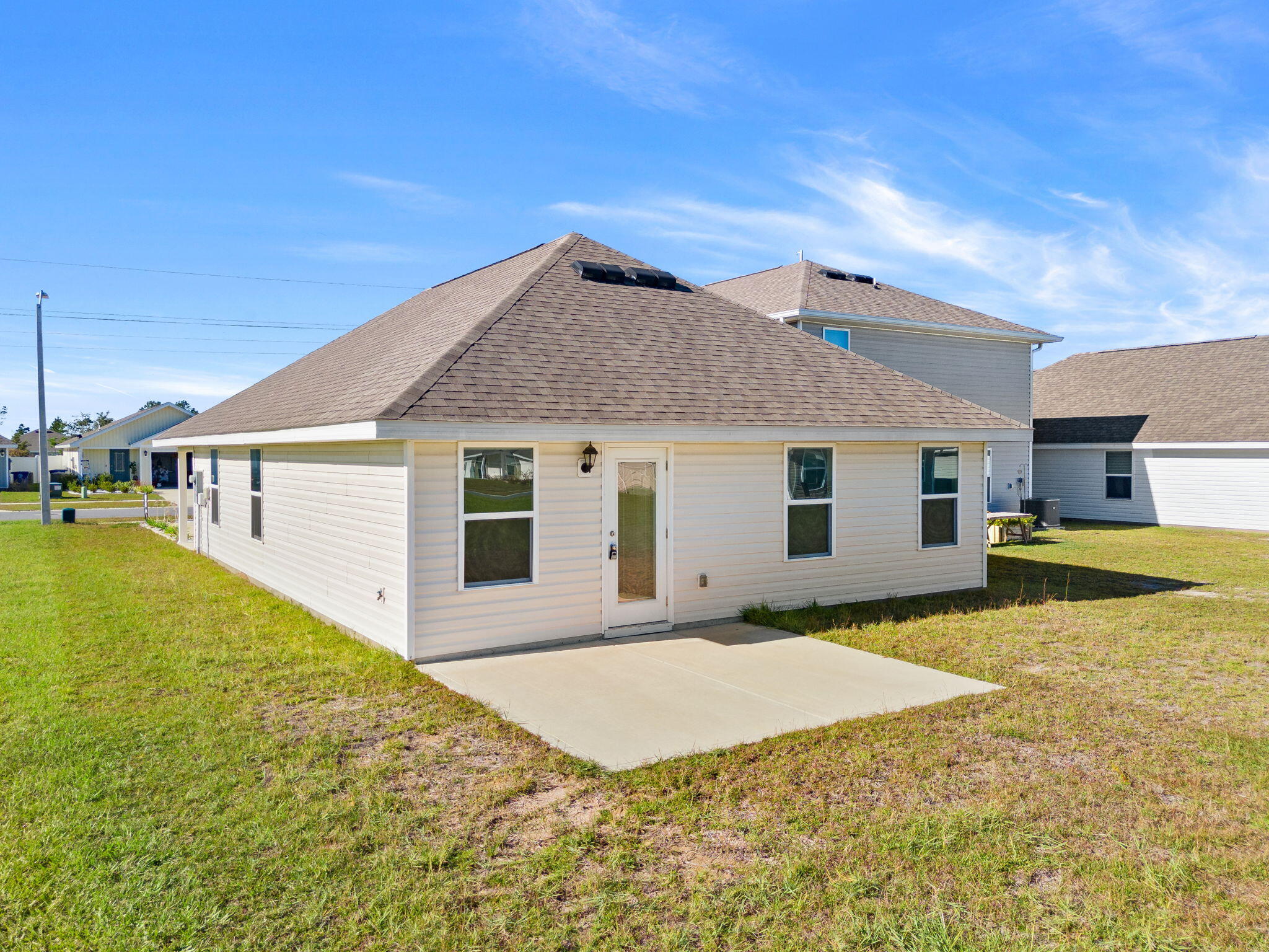 6570 Atkins Road Panama City, FL 32404 - Photo 32 of 50 a view of a house with pool and a yard