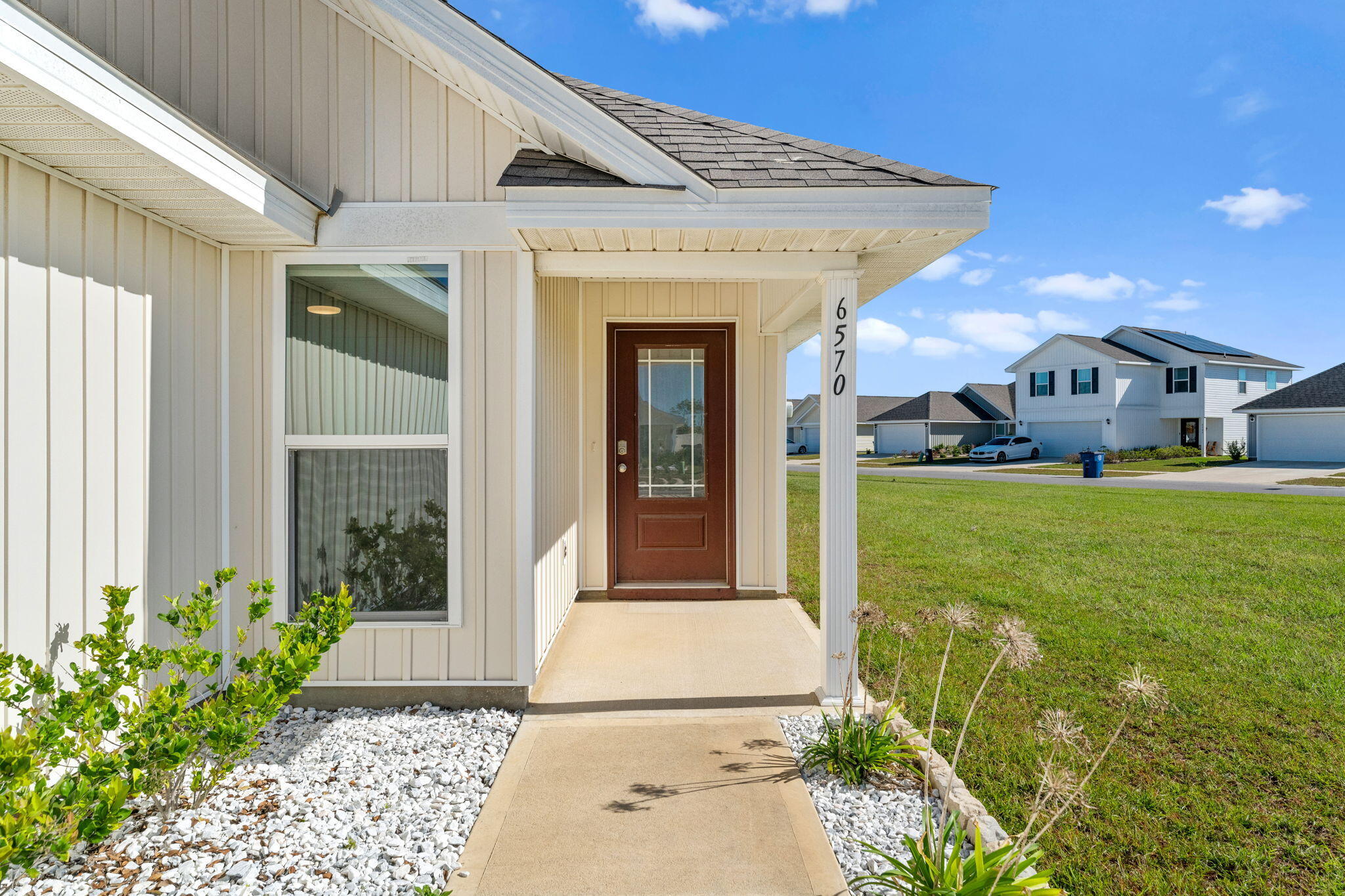 6570 Atkins Road Panama City, FL 32404 - Photo 4 of 50 a front view of a house with garden