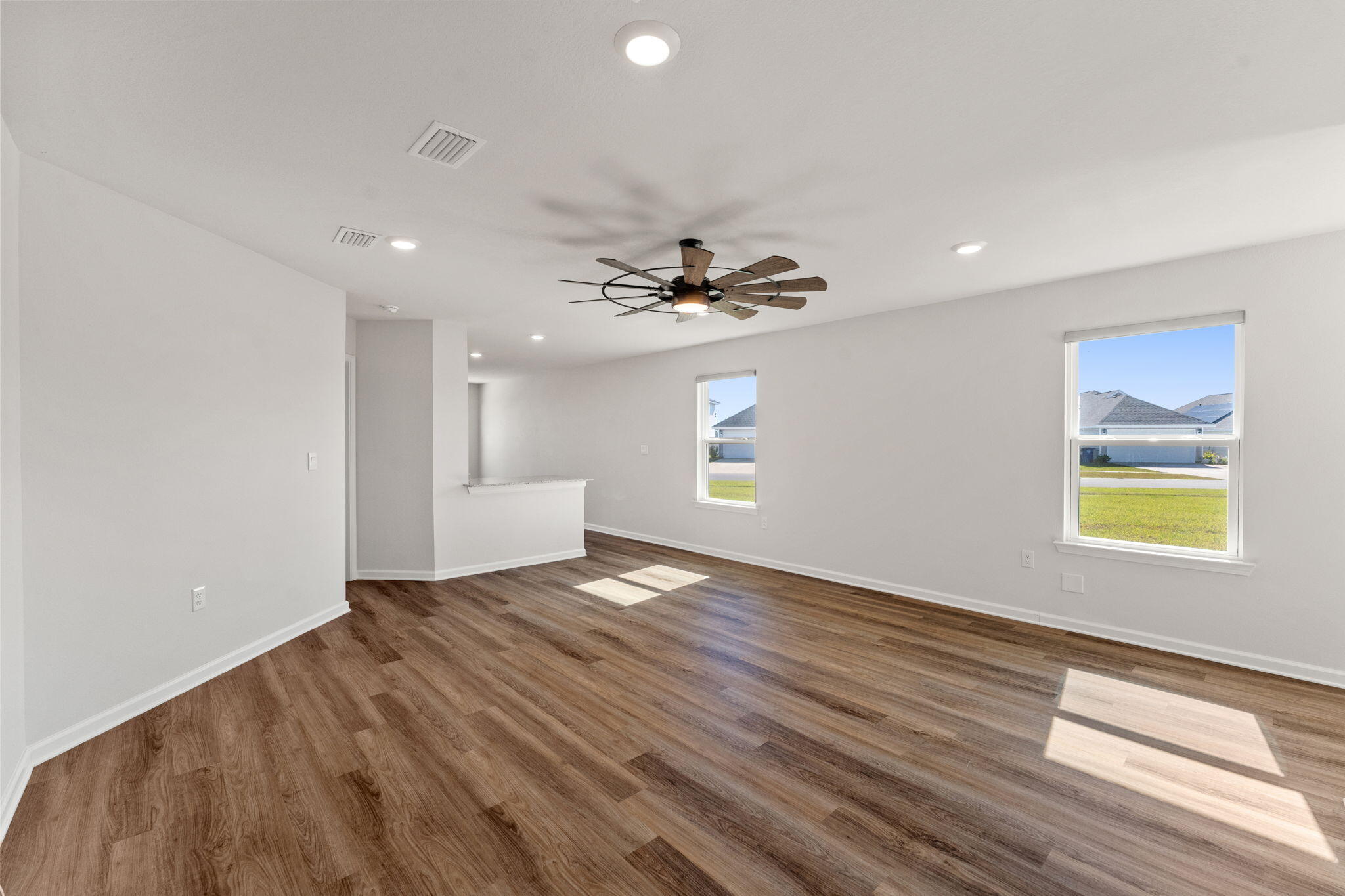 6570 Atkins Road Panama City, FL 32404 - Photo 7 of 50 a view of an empty room with a window and wooden floor