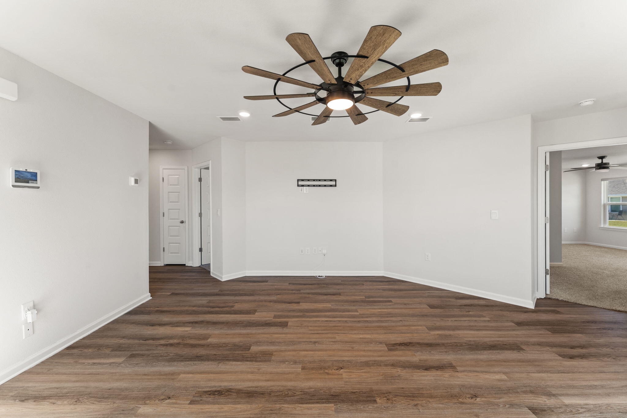 6570 Atkins Road Panama City, FL 32404 - Photo 8 of 50 a view of a room with wooden floor and ceiling fan