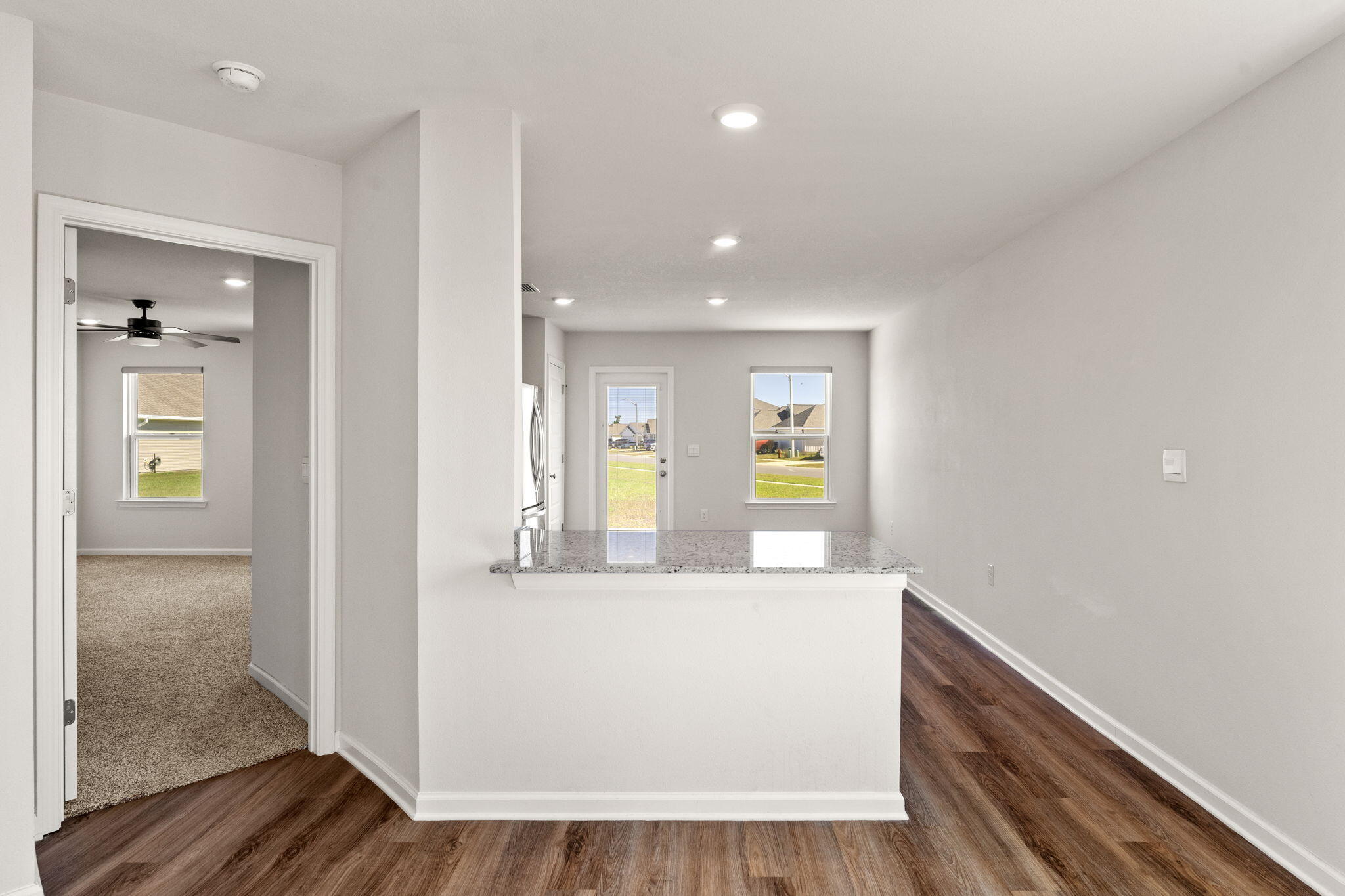 6570 Atkins Road Panama City, FL 32404 - Photo 10 of 50 a view of a hallway with wooden floor and living room