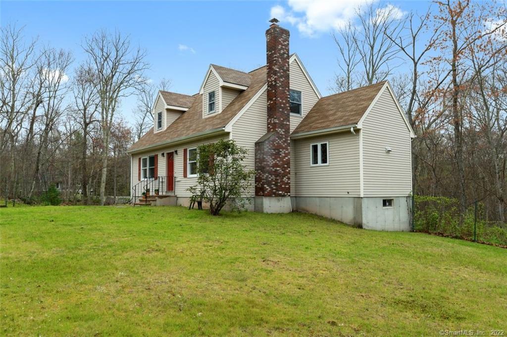 55 Maple Street Chester, CT 06412 - Photo 1 of 1 a view of a yard in front of a house with plants and large tree