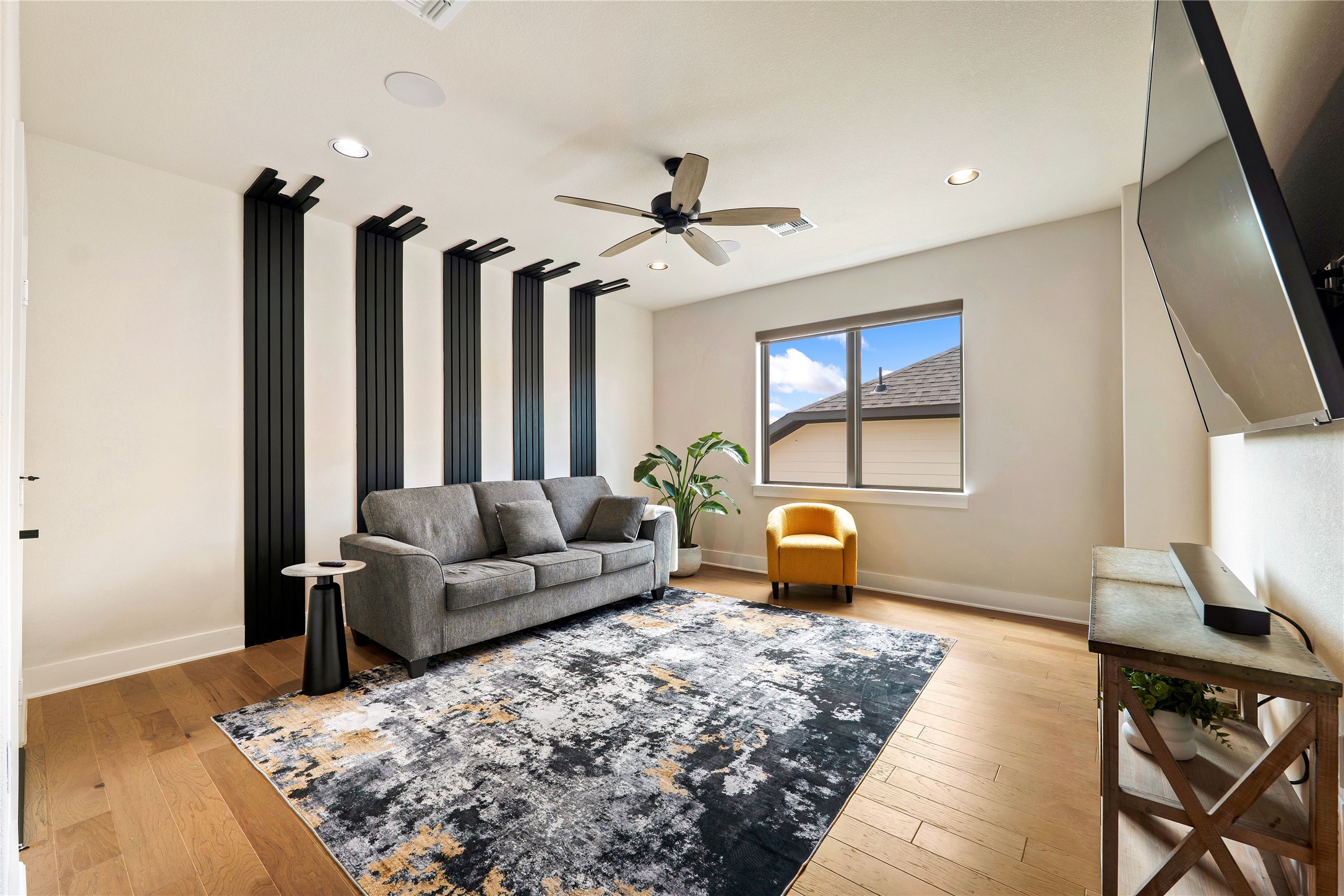2408 Nate's Place Georgetown, TX 78633 - Photo 22 of 40 A contemporary living area boasts rich hardwood flooring and a stylish ceiling fan.