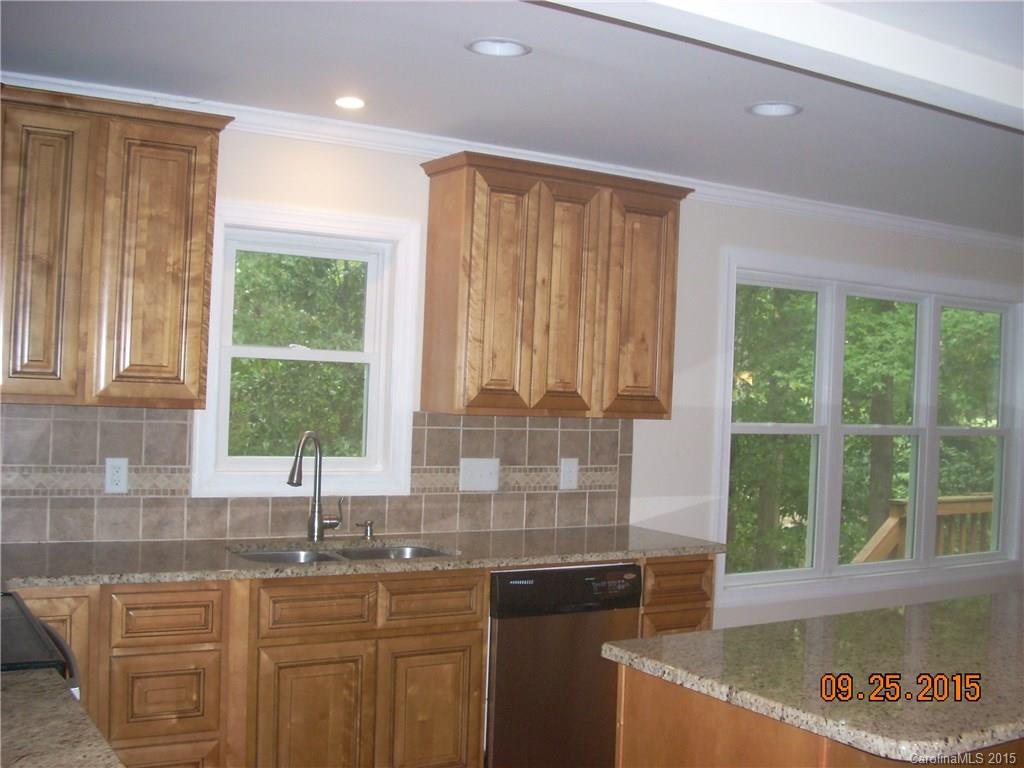 9424 Fairway Ridge Road Charlotte, NC 28277 - Photo 3 of 19 a kitchen with granite countertop a sink and a window