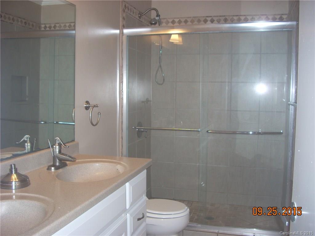 9424 Fairway Ridge Road Charlotte, NC 28277 - Photo 7 of 19 a bathroom with a granite countertop shower sink vanity and toilet