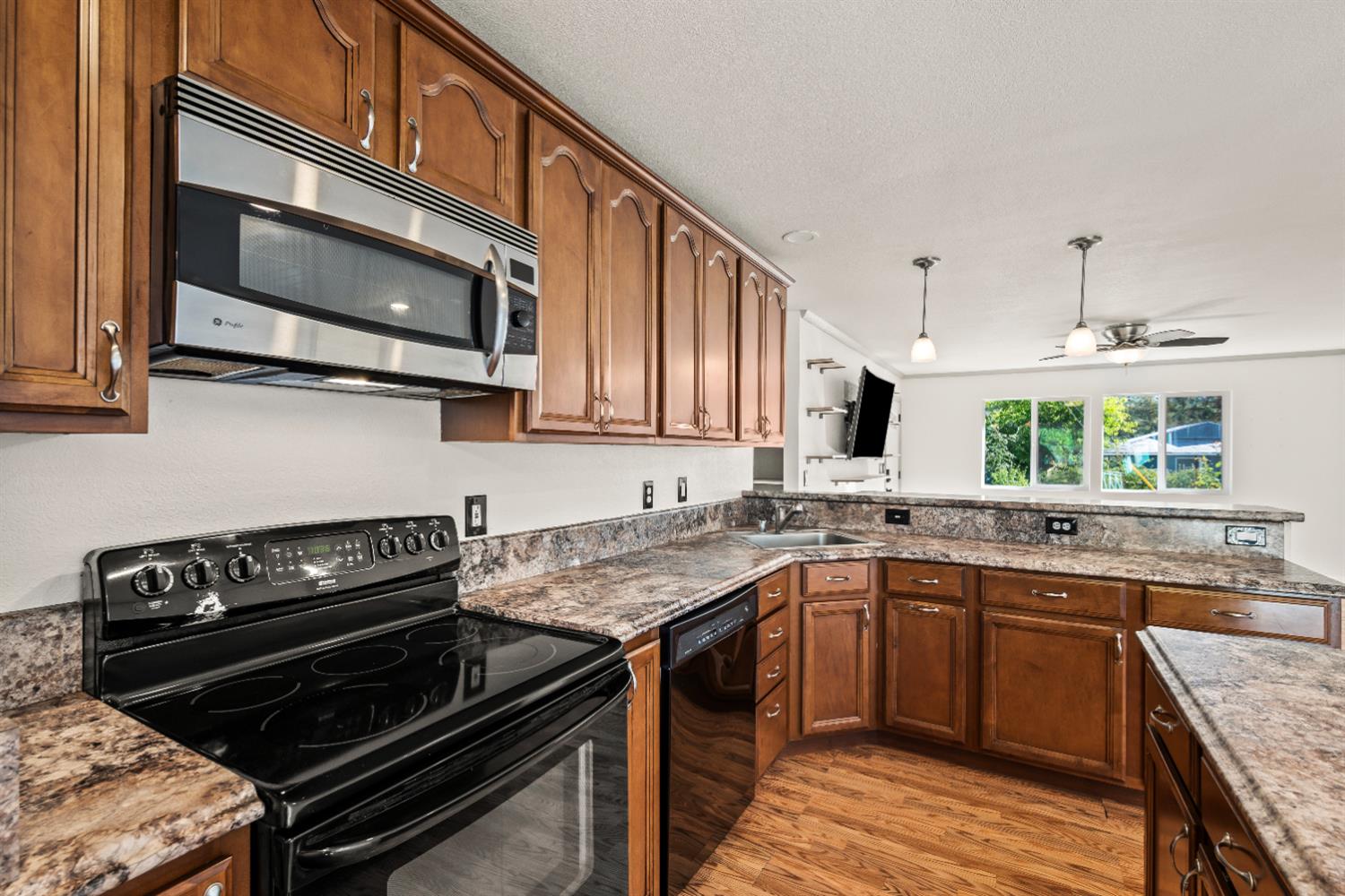 4818 Fall Street El Dorado, CA 95623 - Photo 11 of 31 a kitchen with a stove a sink and a microwave