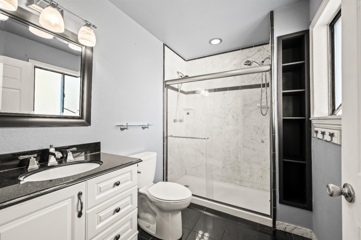 4818 Fall Street El Dorado, CA 95623 - Photo 15 of 31 a bathroom with a granite countertop sink toilet and shower