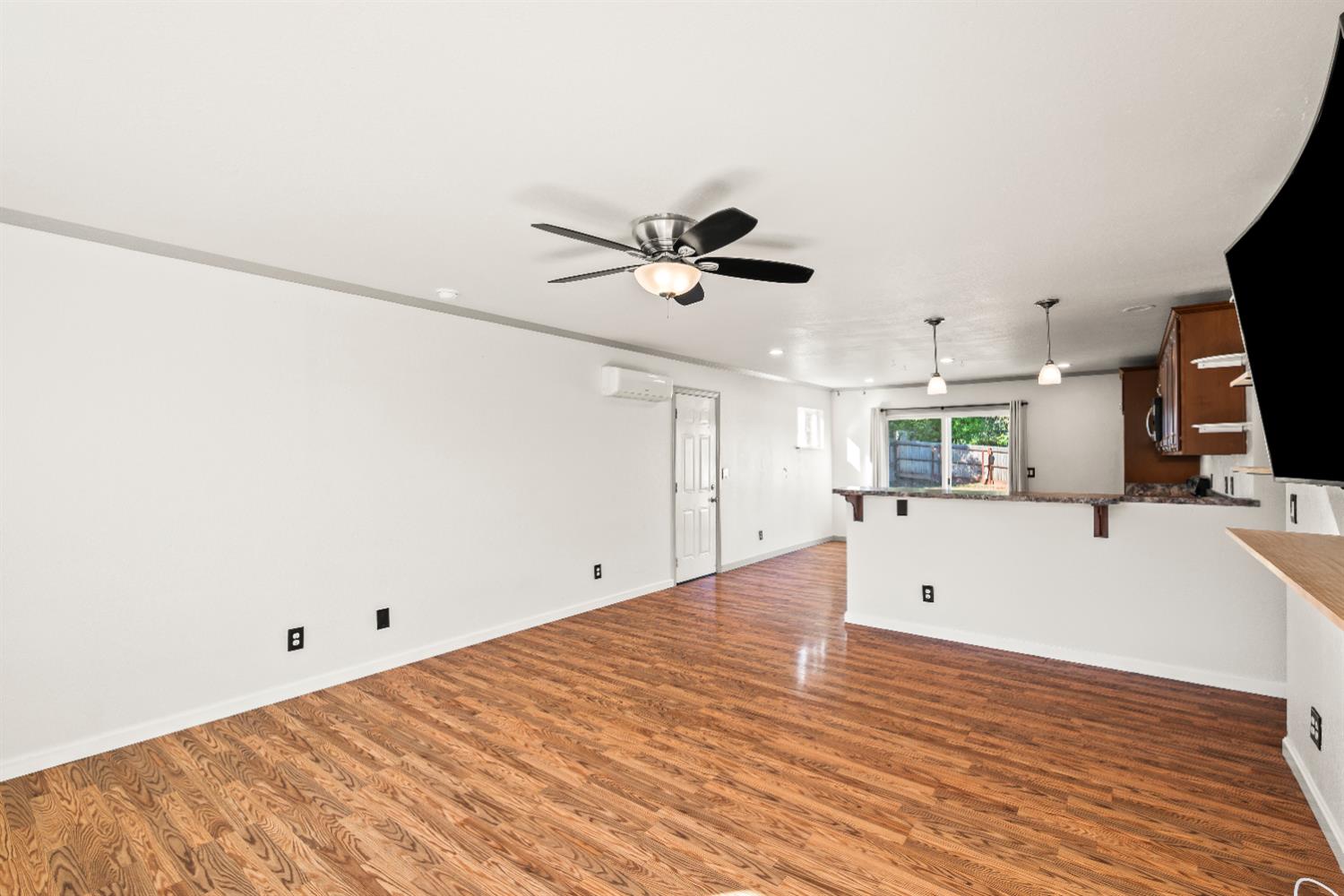 4818 Fall Street El Dorado, CA 95623 - Photo 7 of 31 a view of kitchen and empty room with wooden floor