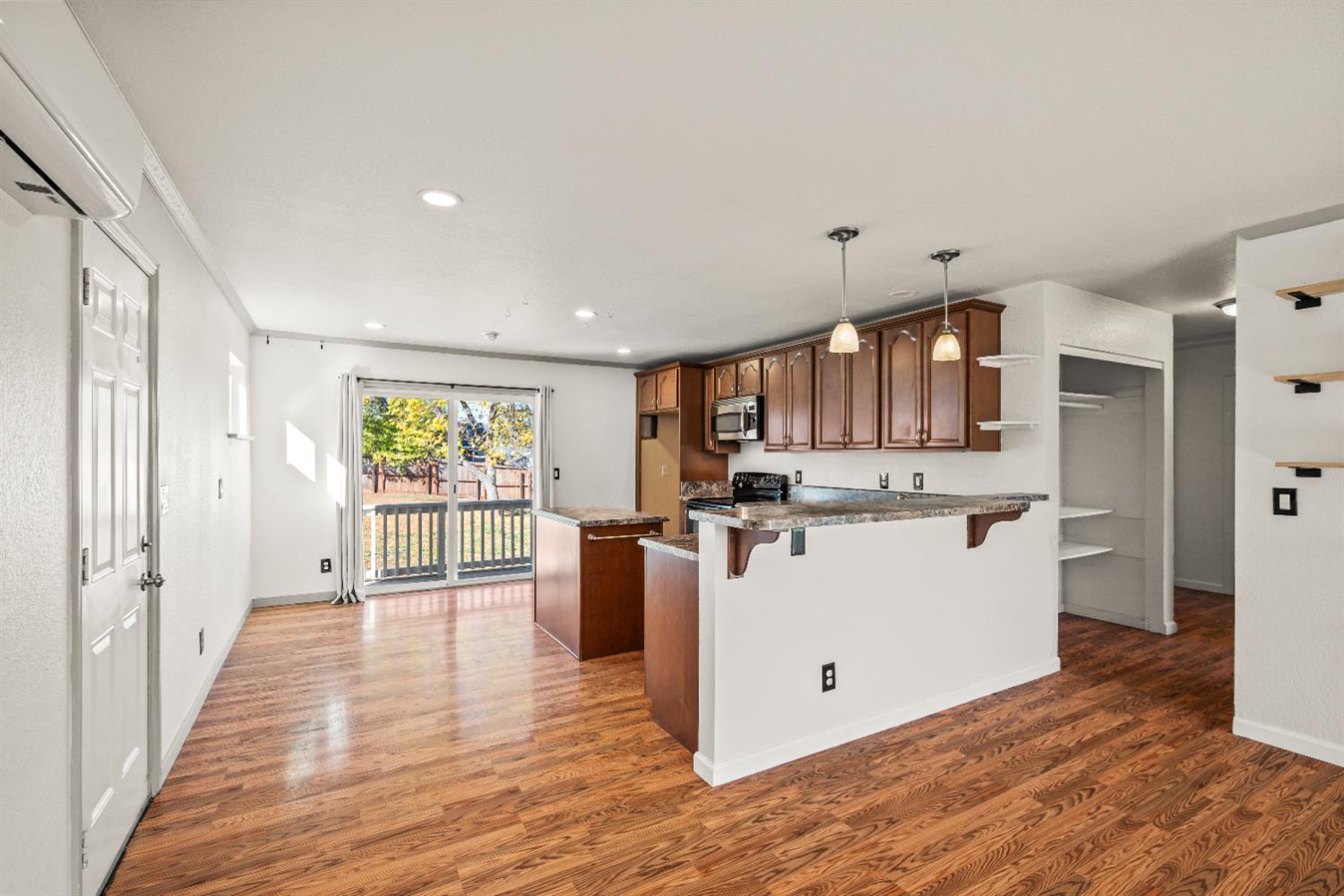 4818 Fall Street El Dorado, CA 95623 - Photo 8 of 31 a view of a kitchen with kitchen island wooden floors stainless steel appliances and windows