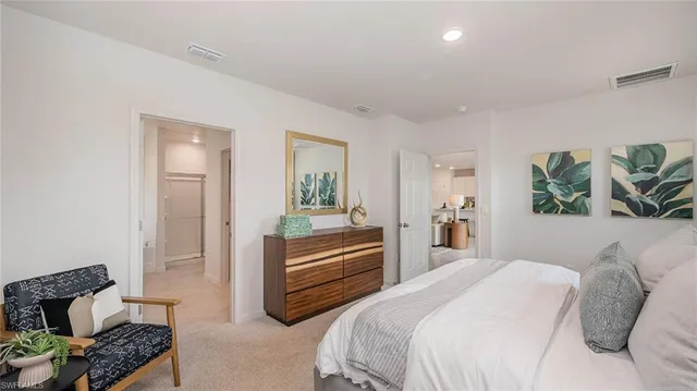 a bedroom with a bed and a couch