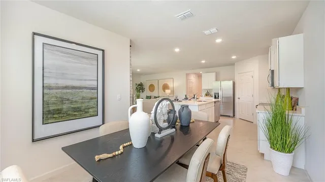 a dining room with furniture and a window