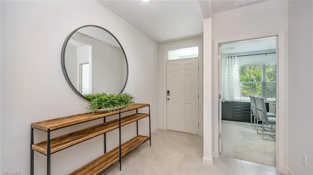 a room with painting on the wall and a potted plant