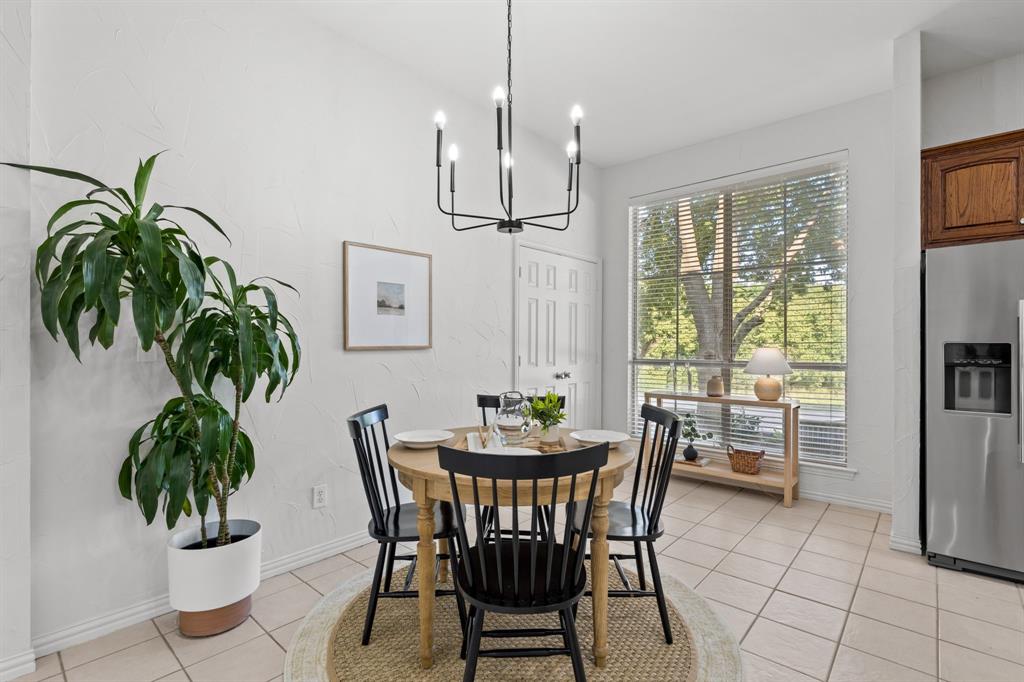 4821 Ravendale Drive Richardson, TX 75082 - Photo 14 of 40 a dining room with furniture potted plants and wooden floor