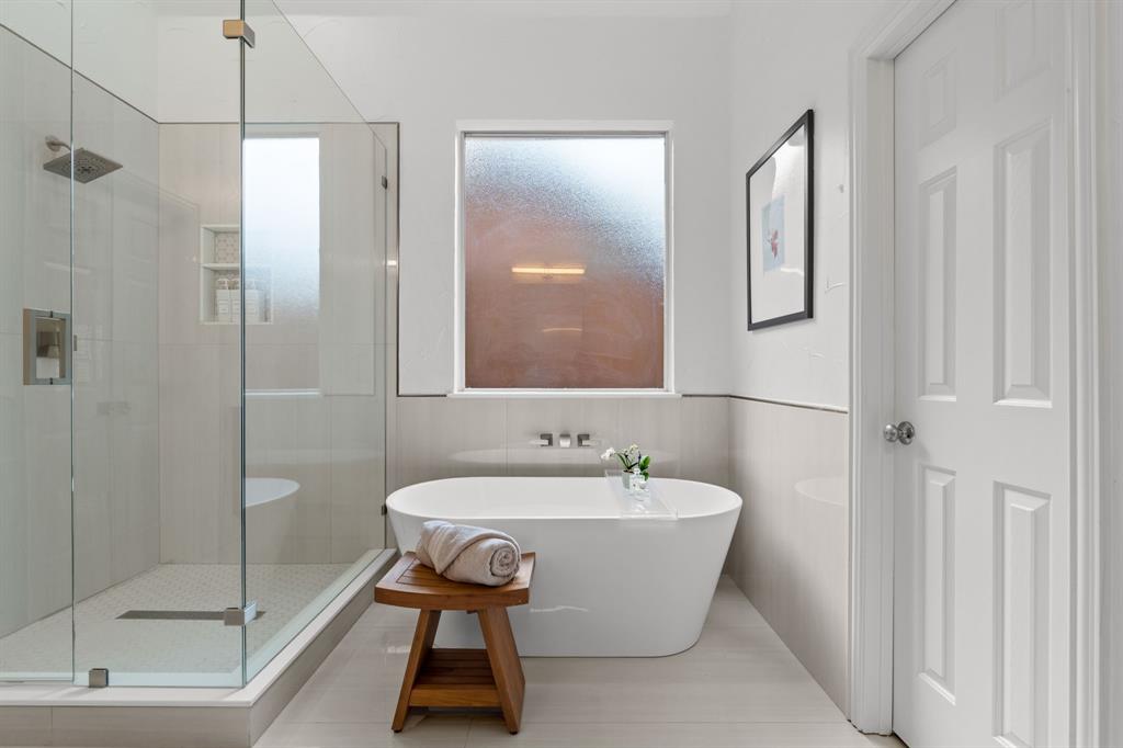 4821 Ravendale Drive Richardson, TX 75082 - Photo 23 of 40 a bathroom with a bathtub and shower