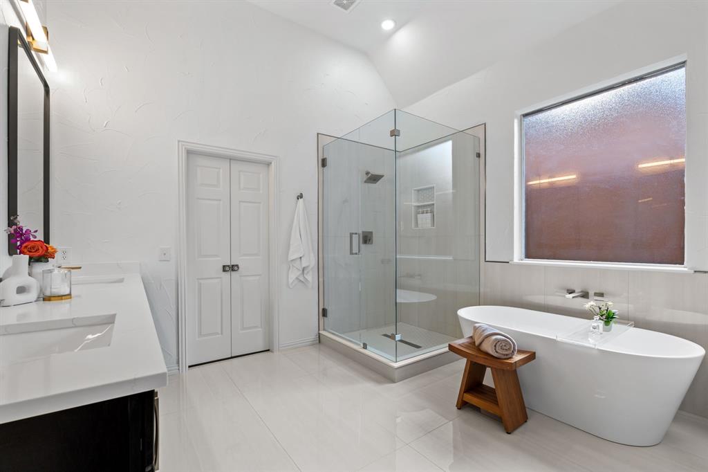 4821 Ravendale Drive Richardson, TX 75082 - Photo 24 of 40 a bathroom with a tub sink shower and mirror