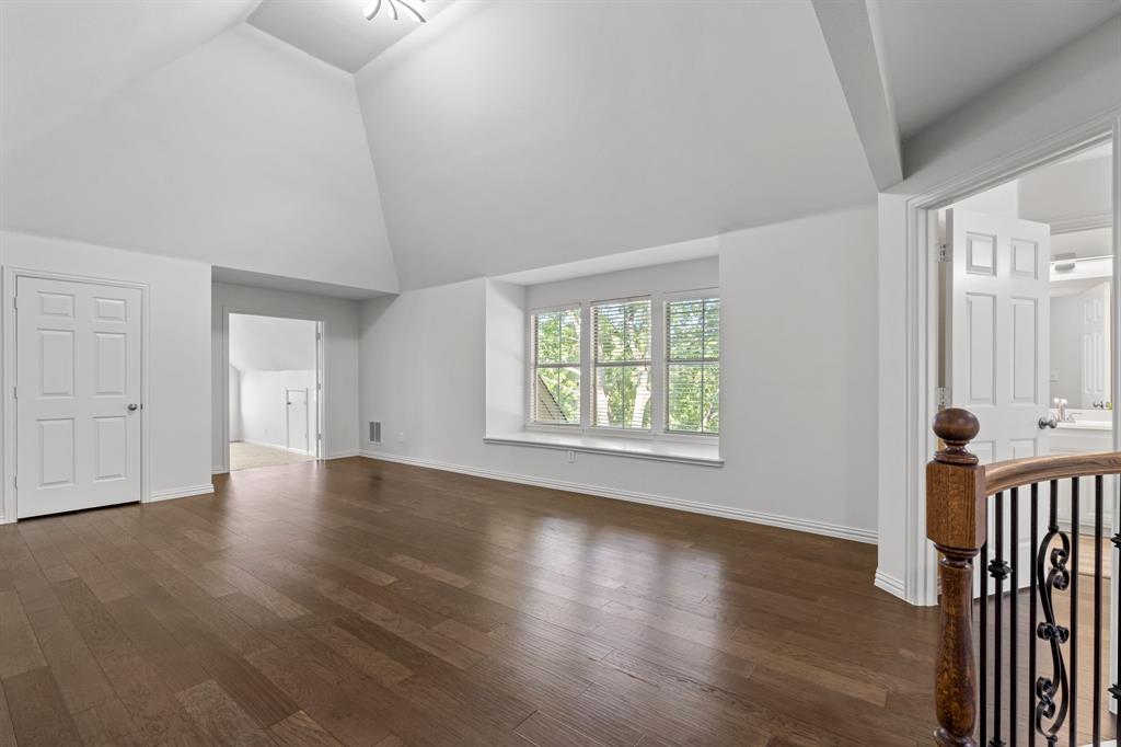 4821 Ravendale Drive Richardson, TX 75082 - Photo 28 of 40 an empty room with wooden floor and windows