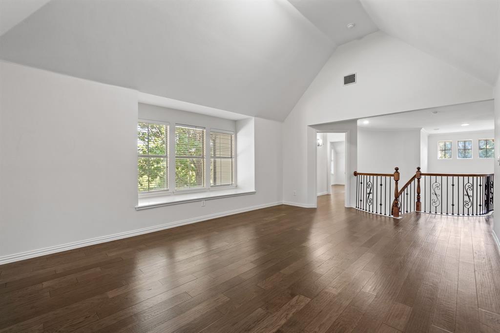 4821 Ravendale Drive Richardson, TX 75082 - Photo 29 of 40 a view of an empty room with wooden floor and a window