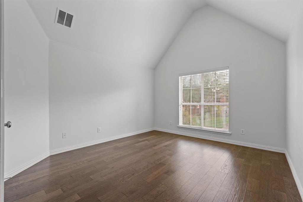 4821 Ravendale Drive Richardson, TX 75082 - Photo 32 of 40 an empty room with wooden floor and windows