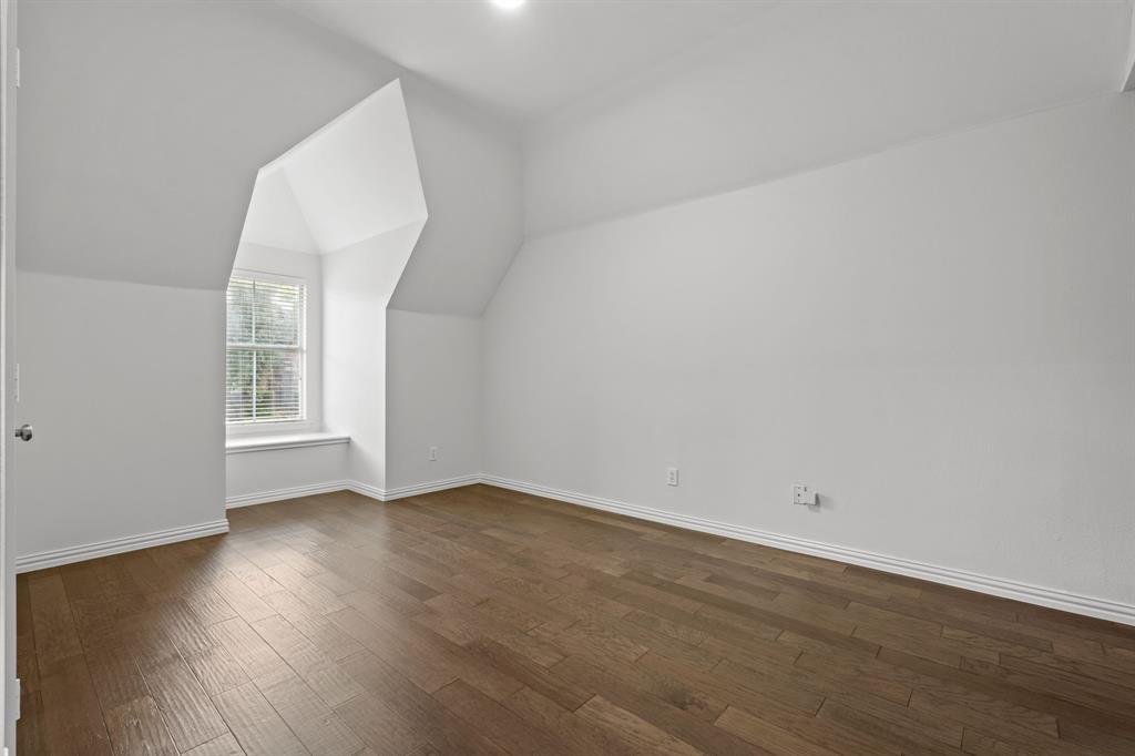 4821 Ravendale Drive Richardson, TX 75082 - Photo 34 of 40 a view of an empty room with wooden floor and a window