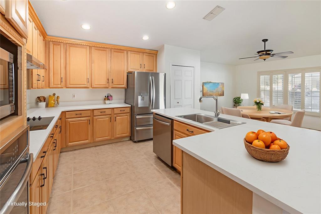 729 Strihal Loop Oakland, FL 34787 - Photo 12 of 33 a kitchen with a sink a stove and chairs