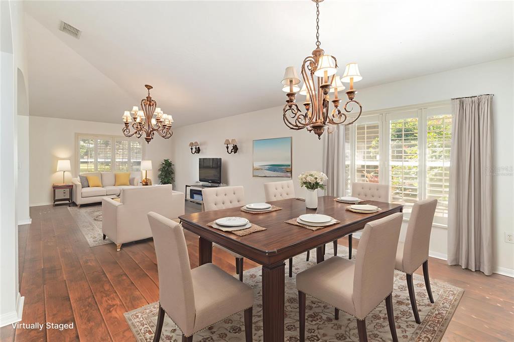 729 Strihal Loop Oakland, FL 34787 - Photo 6 of 33 a view of a dining room with furniture a chandelier and wooden floor
