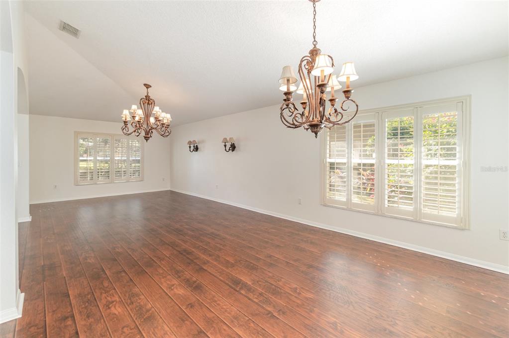 729 Strihal Loop Oakland, FL 34787 - Photo 8 of 33 a view of an empty room with wooden floor and a window