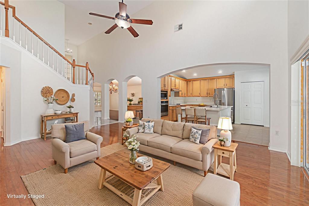 729 Strihal Loop Oakland, FL 34787 - Photo 9 of 33 a living room with furniture a rug and a chandelier