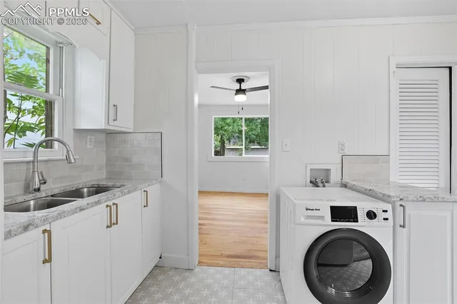 a view of a kitchen with sink washer and dryer