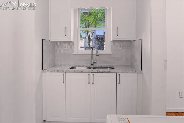 a kitchen with kitchen island granite countertop cabinets and window