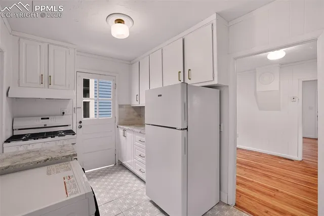 a white refrigerator freezer sitting inside of a kitchen