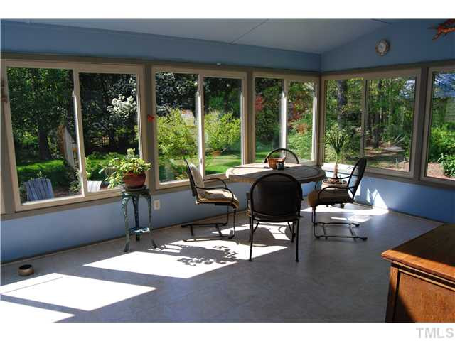 308 Baytree Lane Raleigh, NC 27615 - Photo 8 of 17 Sun room features all new windows, flooring, and door to deck!