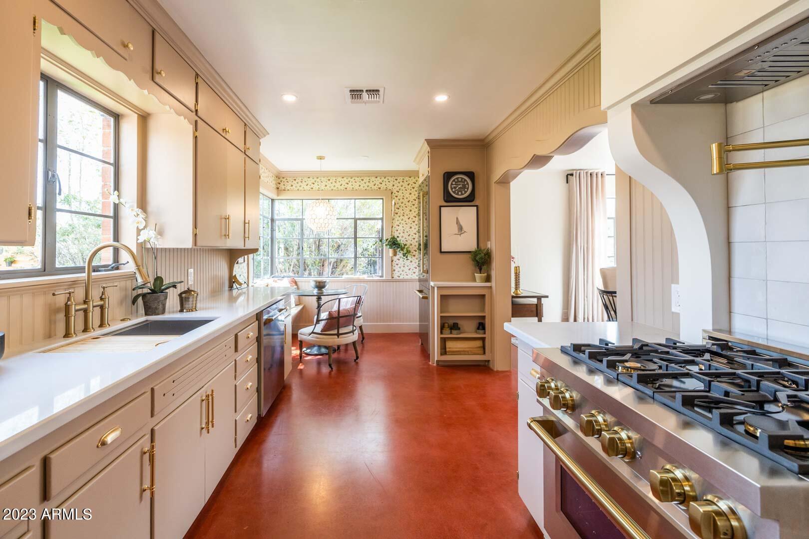 302 West Granada Road Phoenix, AZ 85003 - Photo 31 of 81 a large kitchen with stainless steel appliances a stove and a large window